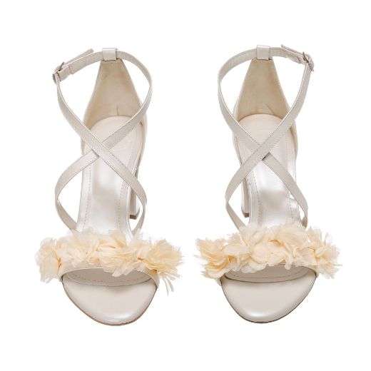 Handmade ivory bridal block heel sandals with soft floral embellishments and elegant cross straps