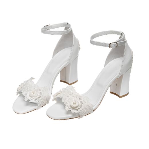 Handmade white bridal block heel sandals with floral and pearl embellishments on the front strap and heel