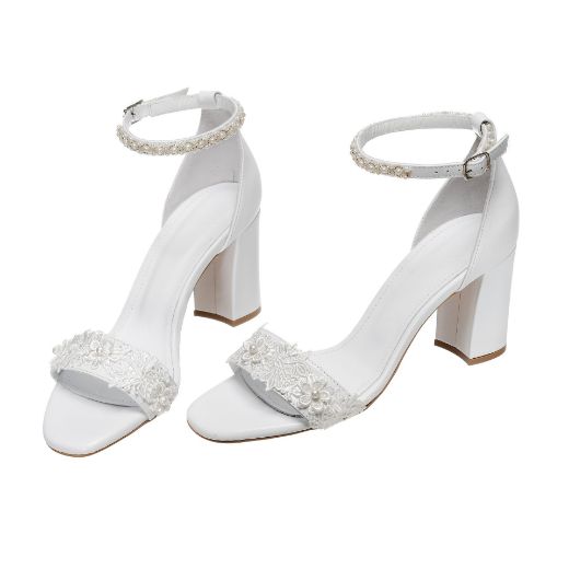 Handmade white bridal block heel sandals with pearl ankle strap and lace embellishments