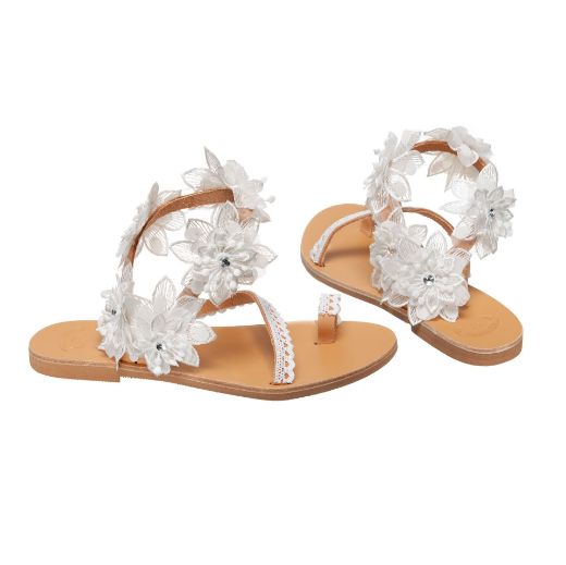 Handmade flat bridal sandals with white flowers around the ankle
