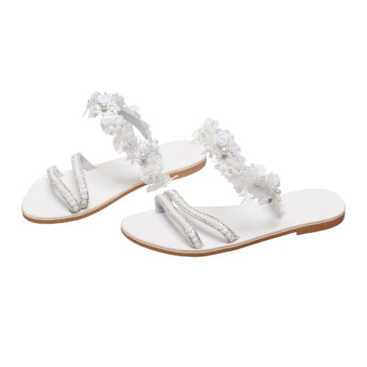 Handmade flat bridal sandals with floral ankle embellishments and pearl straps