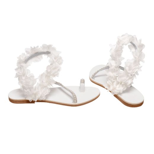 Handmade flat bridal sandals with white flowers around the ankle and crystals