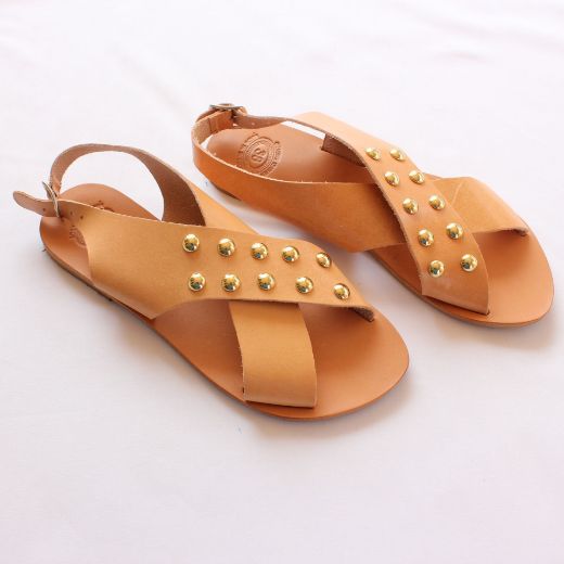 Women’s beige flat sandals with crossover straps and gold studs