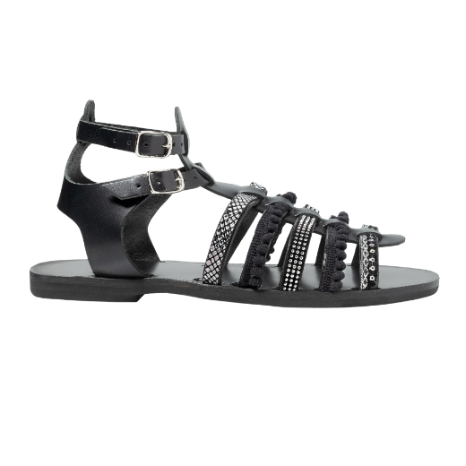 A black sandal with double buckle straps around the ankle and several upper straps adorned with different textures and embellishments.
