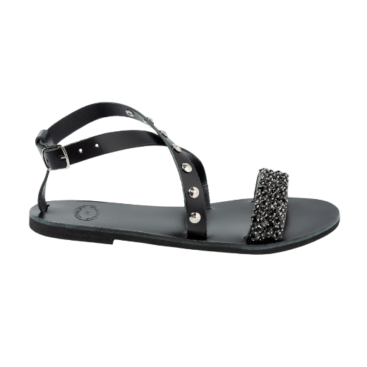 A black sandal with a buckle ankle strap and two upper straps, one of which is decorated with beads or small embellishments.