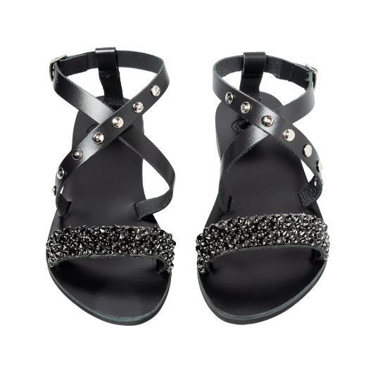 A black sandal with a buckle ankle strap and two upper straps, one of which is decorated with beads or small embellishments.