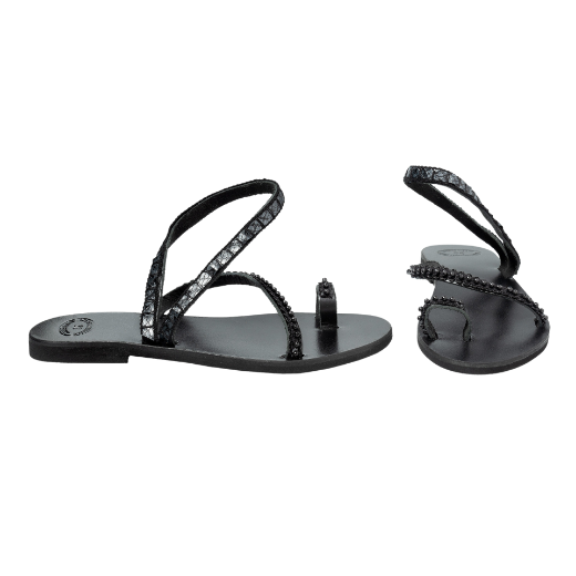 A black sandal with two crisscrossing upper straps and a toe loop, adorned with small beads or decorative elements.