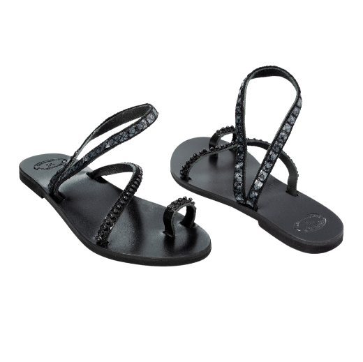 A black sandal with two crisscrossing upper straps and a toe loop, adorned with small beads or decorative elements.