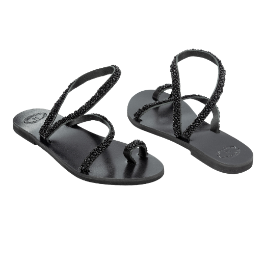 A black sandal with two upper straps, one plain and the other textured, and a loop for the toe.