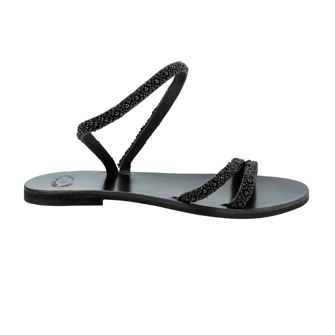 A black sandal with a single looped strap around the ankle and two thin upper straps, embellished with small decorative elements.
